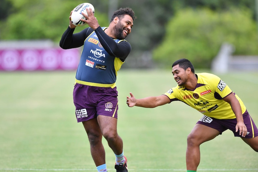 Sam Thaiday evades the attentions of Anthony Millford with a smile on his face at training.