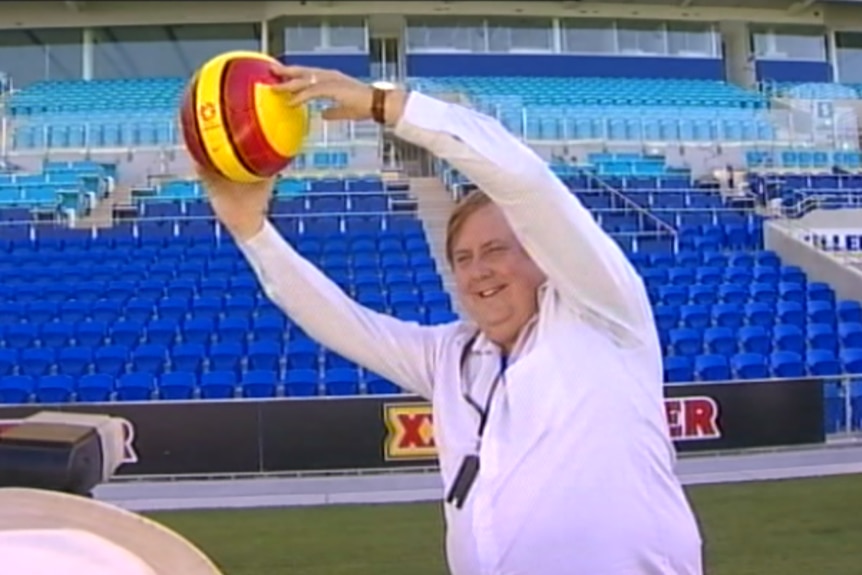 Clive Palmer with a football.