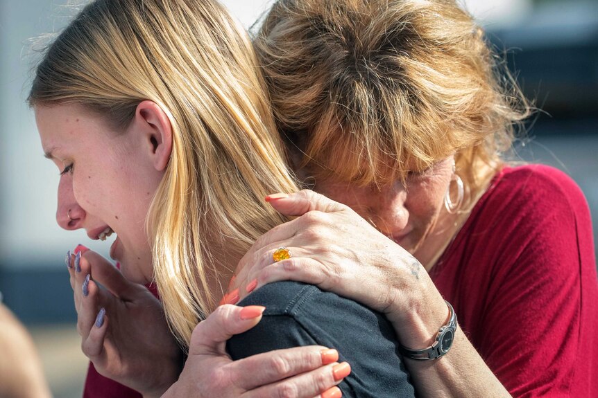 Santa Fe High School student Dakota Shrader is comforted by her mother.