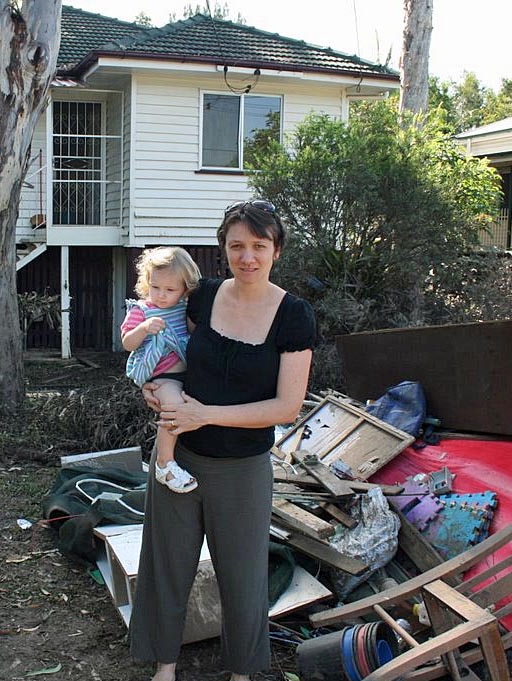 Bronwyn Powell with her daughter Lena outside their flooded Fairfield home in January.