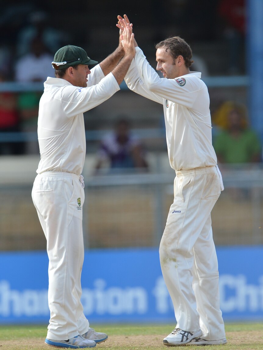 On top ... Nathan Lyon (R) and Ricky Ponting celebrate the wicket of Narsingh Deonarine