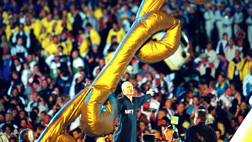 Midnight Oil perform on stage at the Closing Ceremony of the Sydney 2000 Olympic Games.