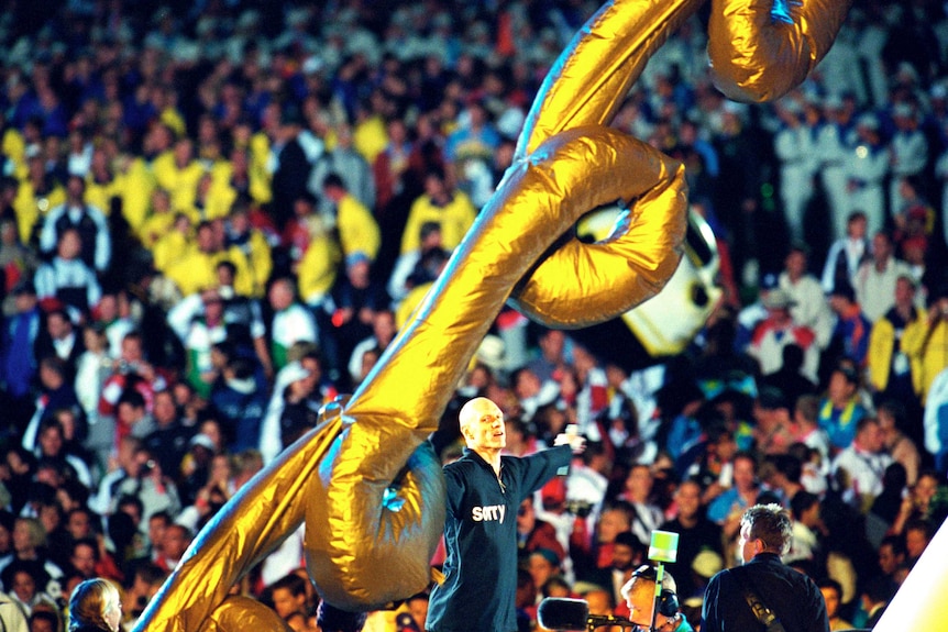 Midnight Oil perform on stage at the Closing Ceremony of the Sydney 2000 Olympic Games.