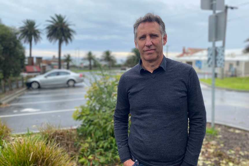 A man standing in a car park