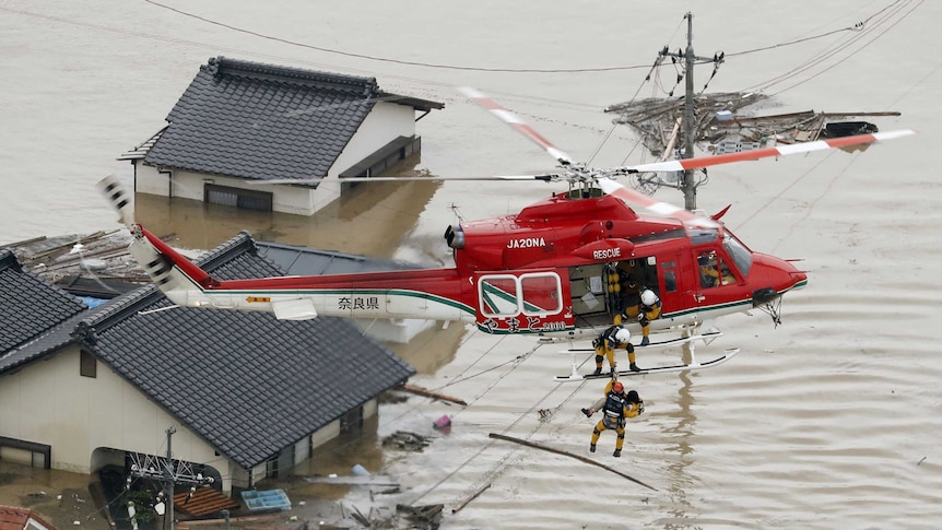 A resident is rescued from a submerged house in Kurashiki. (Photo: Reuters/Kyodo)