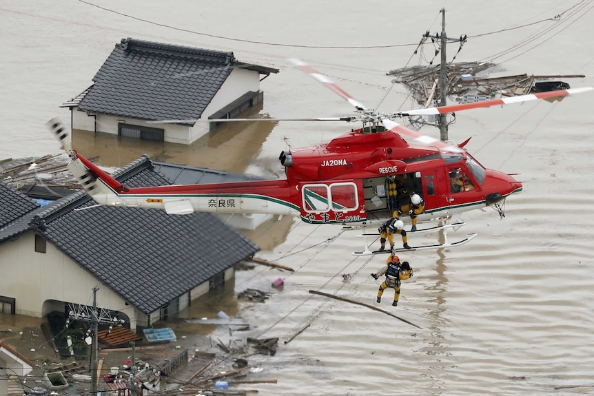 A resident is rescued from a submerged house in Kurashiki.