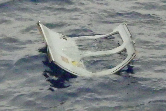 A piece of debris appearing to be a door is shown floating at sea