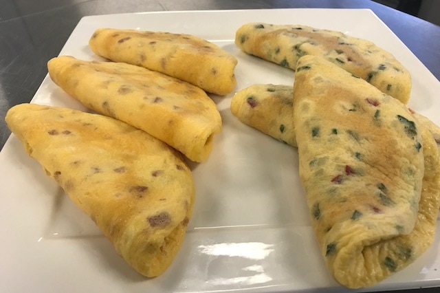 Several omelettes sit on the counter inside the Ipswich Sunny Queens factory