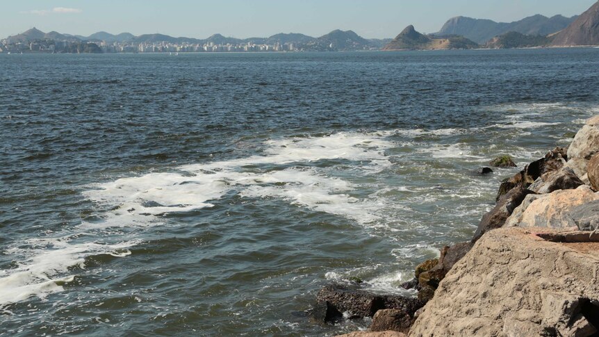 Polluted water near rocks at Flamengo Beach in Rio