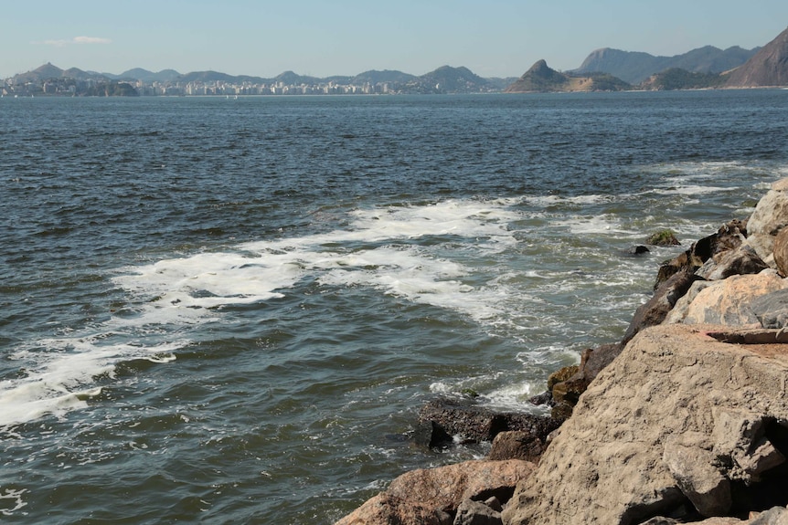 Polluted water near rocks at Flamengo Beach in Rio