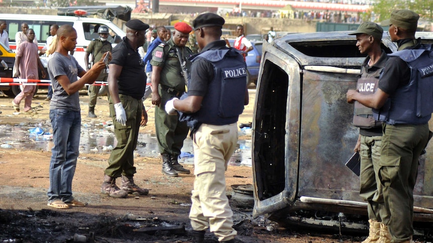 Police at scene of suicide bombing at bus station in Kano Nigeria