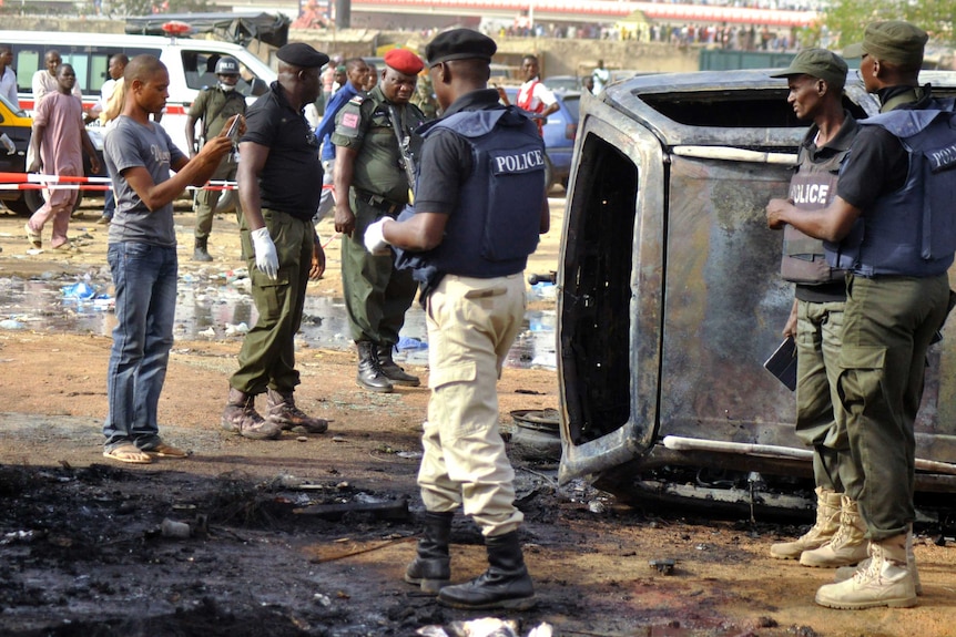 Police at scene of suicide bombing at bus station in Kano Nigeria