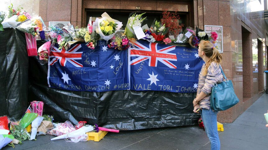 Australian flags form part of floral tribute to hostages