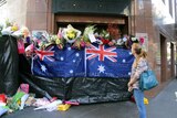 Australian flags form part of floral tribute to hostages