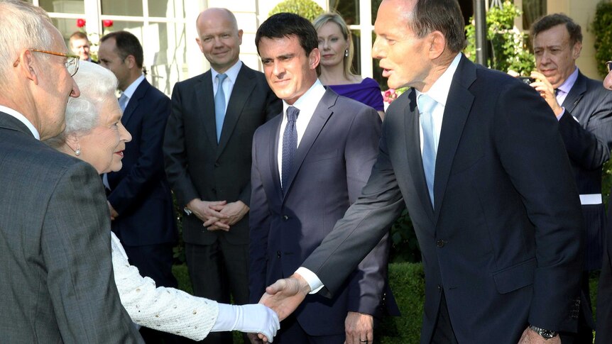 Queen Elizabeth II greets Prime Minister Tony Abbott during the Queen's Birthday Garden Party in Paris.