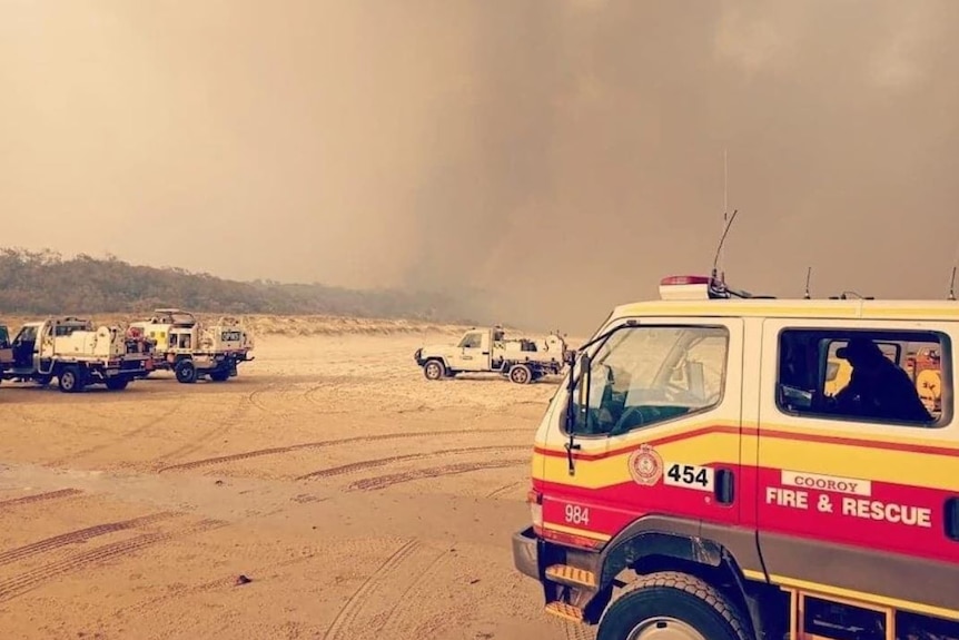 Fire crews park on the beach at Fraser Island while battling a major bushfire, December 7, 2020.