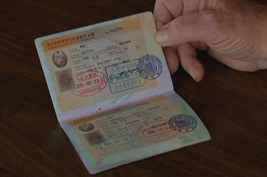 A man's hand holds open a permit. It is written in Hangul, the Korean alphabet.
