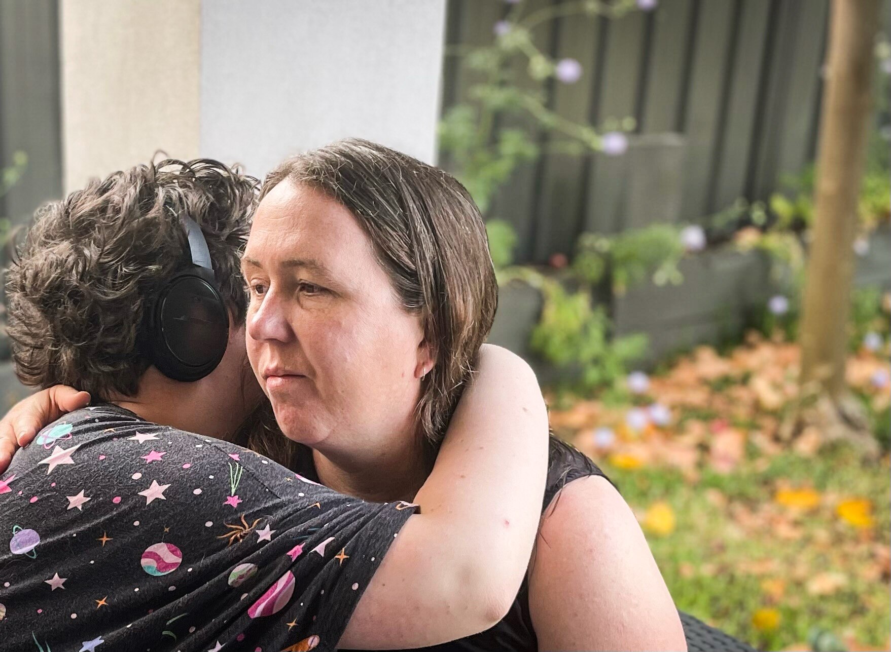 Georgina Ker looks pensive as she hugs her 15-year-old daughter.