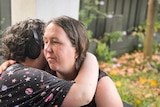 Georgina Ker looks pensive as she hugs her 15-year-old daughter.