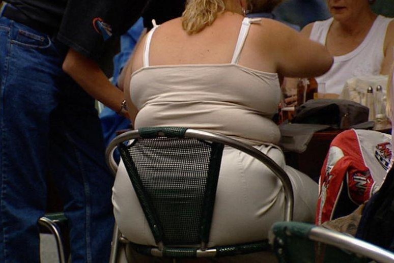A very obese woman sitting on chair at a cafe (File image: ABC TV)