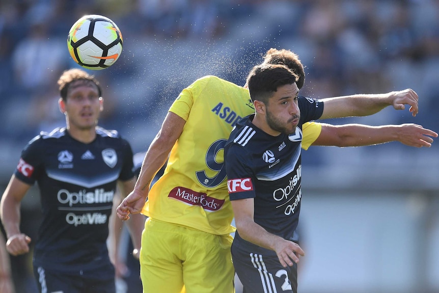 Asdrubal and Stefan Nigro contest for the ball in the Victory versus Mariners A-League match.