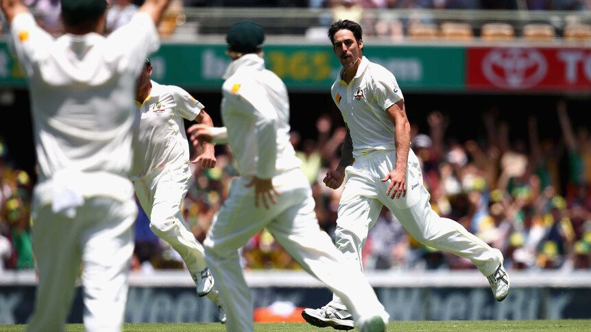 Mitchell Johnson celebrates the wicket of Jonathan Trott on day two at the Gabba