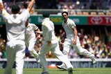 Mitchell Johnson celebrates the wicket of Jonathan Trott on day two at the Gabba