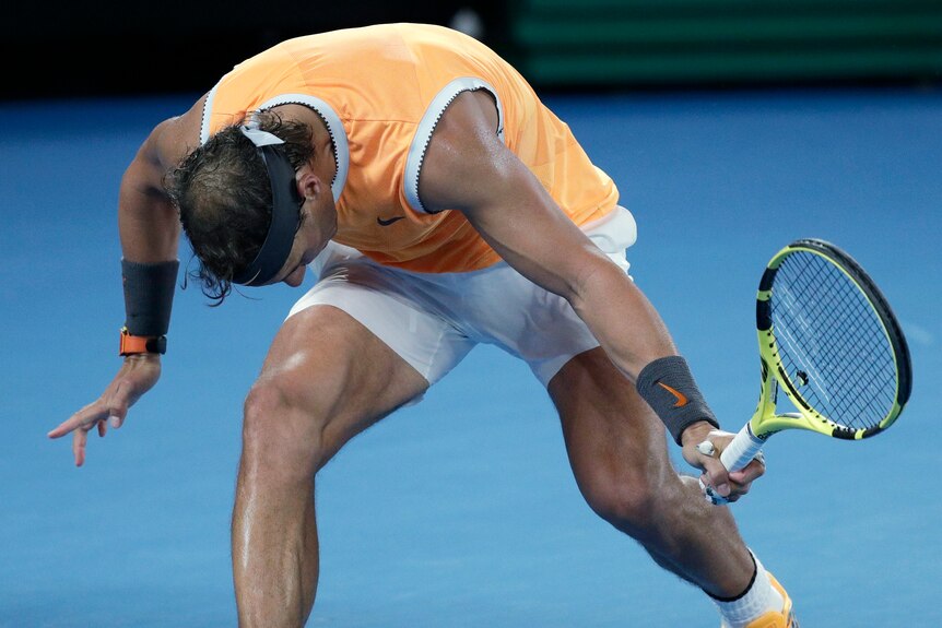 Rafael Nadal lurches forward in frustration after a missed backhand in the Australian Open men's final