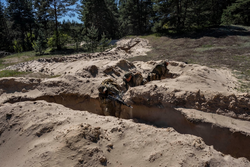 Ukrainian soldiers in trenches during military training