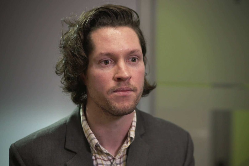 Head shot of Patrick Sloyan with a blurred office background