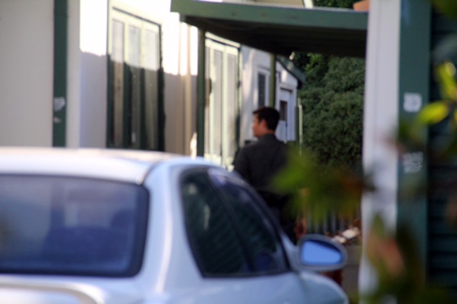 A policeman and a car outside a house