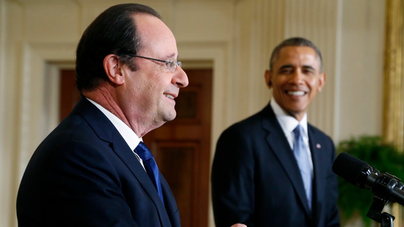 Barack Obama listens as French president Francois Hollande addresses a joint news conference in the White House on February 11, 2014