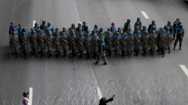 Thai army soldiers face off with anti-government "red-shirt" protesters on a highway in the northern