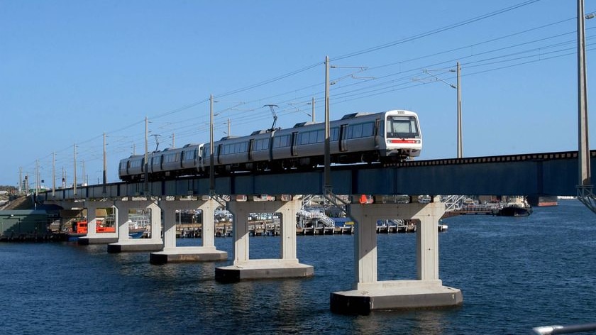 A train makes its way across a rail bridge