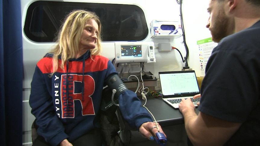 a woman with her sleeve rolled up getting her blood pressure checked