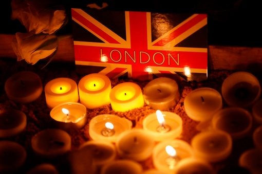 Candles burning in front of a picture of the Union Jack flag in Trafalgar Square during a vigil for the victims of the attack.