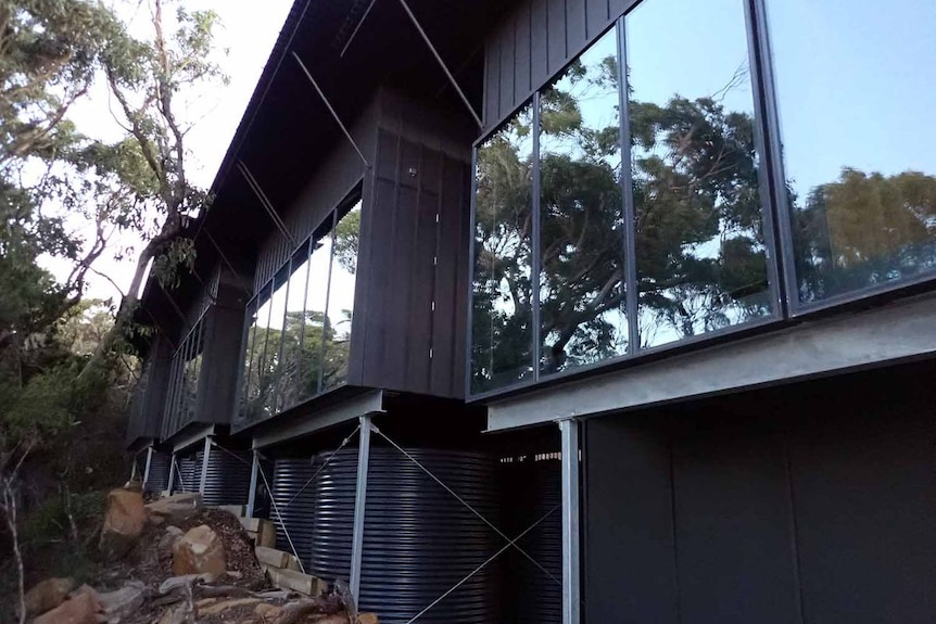 A fancy glass windowed building in the bush