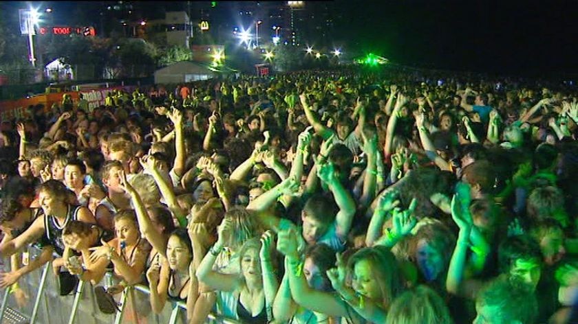 TV still of large crowd partying at Gold Coast schoolies event in city at Surfers Paradise
