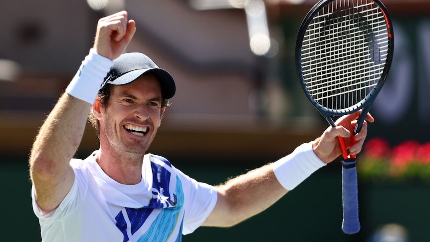Andy Murray grins widely and raises his arms in triumph after winning a match a tournament in the US.