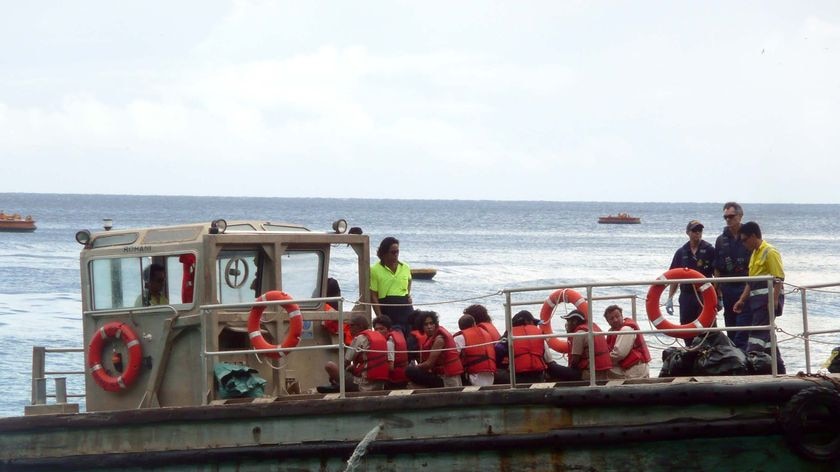 A boat carrying asylum seekers heads to dock at Christmas Island.