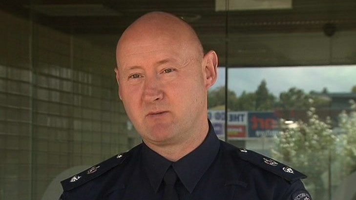 A police officer speaks to the media outside a police station in Melbourne's south-east.