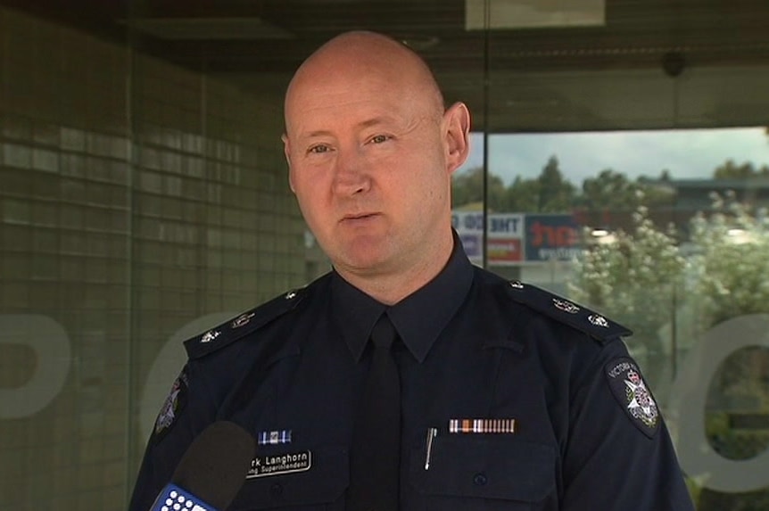 A police officer speaks to the media outside a police station in Melbourne's south-east.