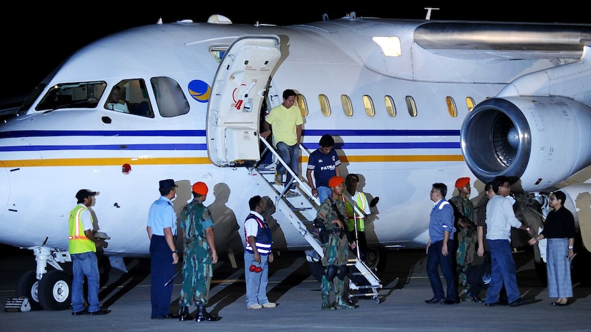 Indonesian sailors get off the plane upon their arrival in Jakarta.