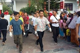 Indonesian police officers carry the body of Australian man Gregory Robert Jones