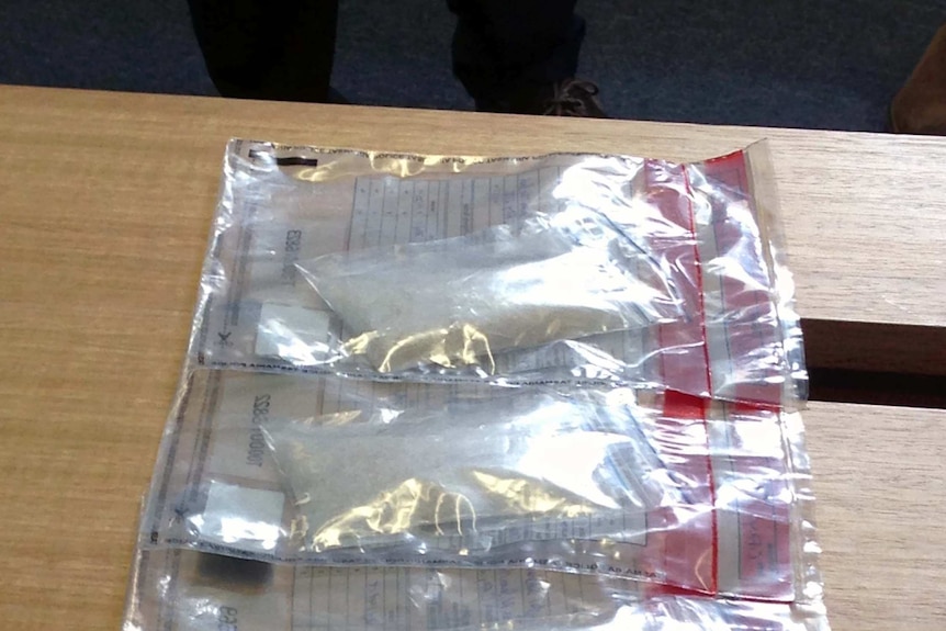 Plastic bags of crystal meth and cocaine displayed by Tasmania Police.