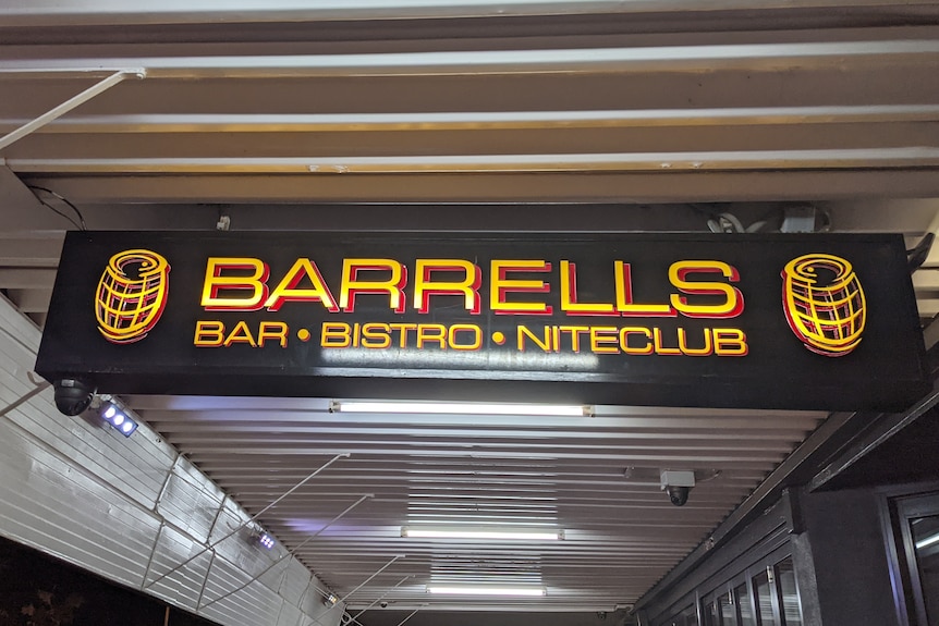 A sign out the front of a nightclub that reads "Barrells".