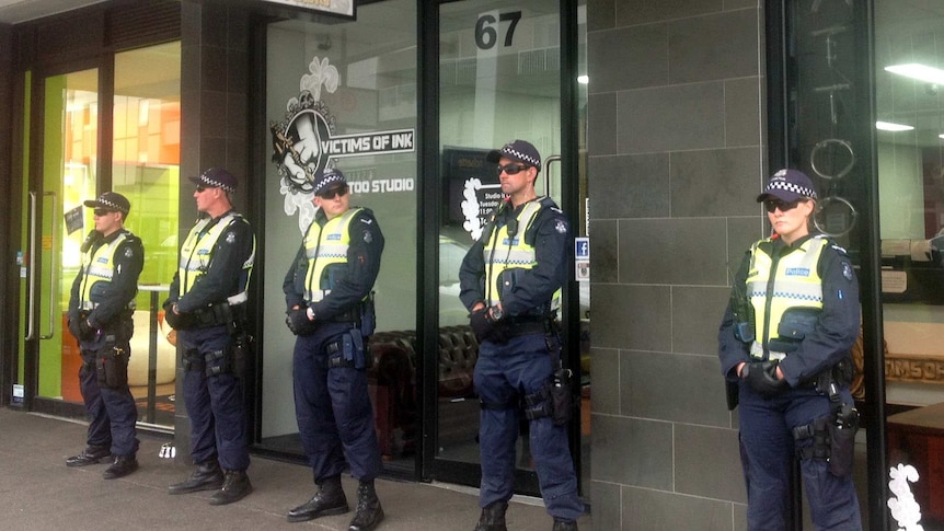 Victoria Police officers guarding the Victims of Ink tattoo parlour in March this year