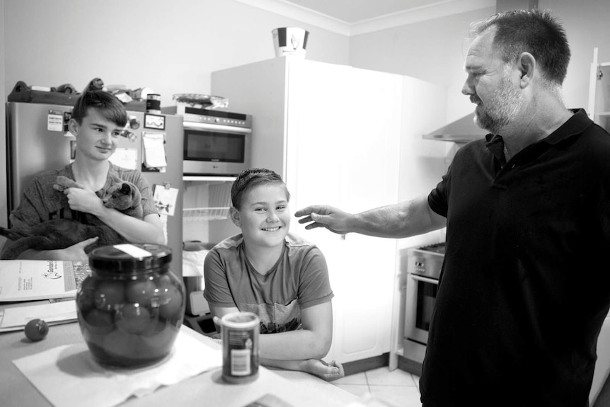 Mark with sons James and Luke in the kitchen depicting the difficulties of being a parent and giving your kids to childcare.