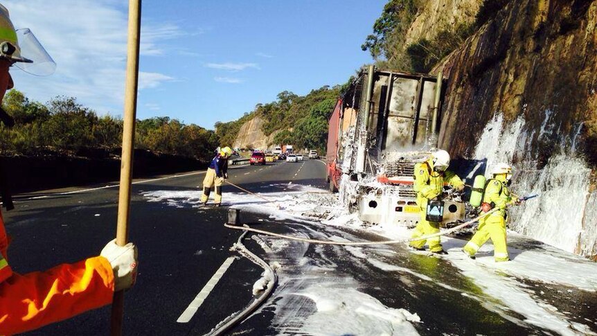 Firefighters extinguish a truck fire