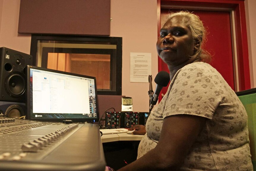 A photo of broadcaster Sylvia Nulpinditj sitting at a radio desk.